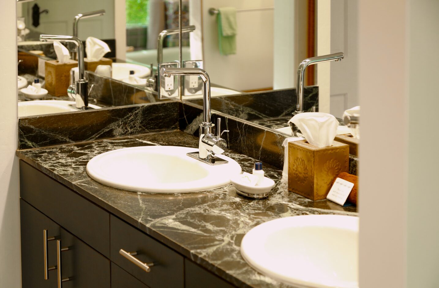 Double vanity sink with a black marble counter top