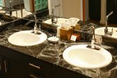 Double vanity sink with a black marble counter top