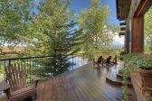 Second Story deck with wooden chairs overlooking a lake