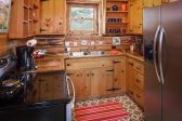 Complete kitchen with large refrigerator and electric stove