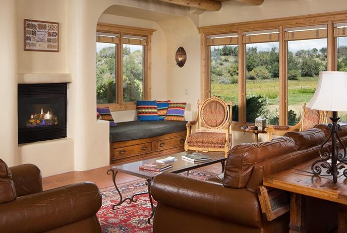 Large living room with fireplace couches and mountain views