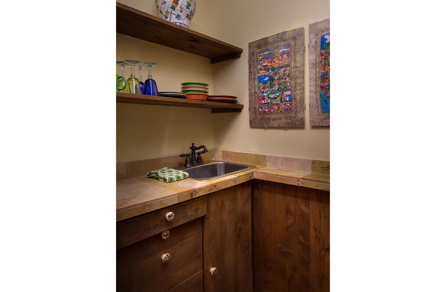 A kitchenette with shelves and dishes