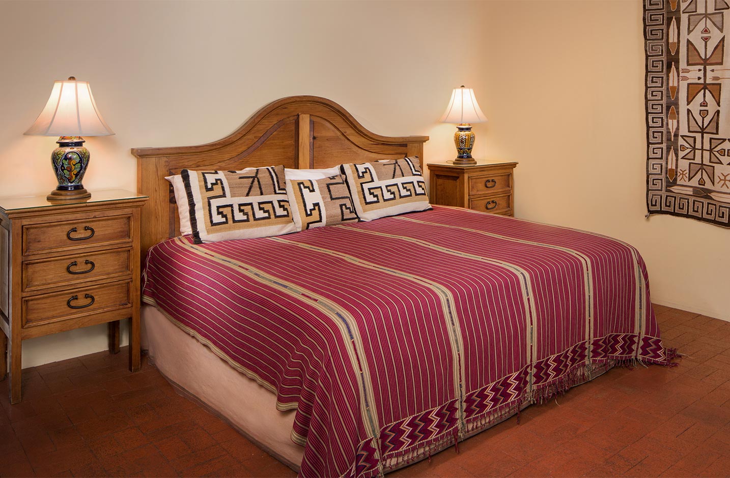 A king size bed with wooden headboard in a large room