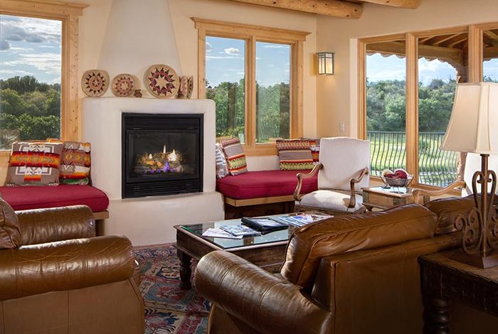 Large living room with gas fireplace and leather sofas panoramic views through large windows