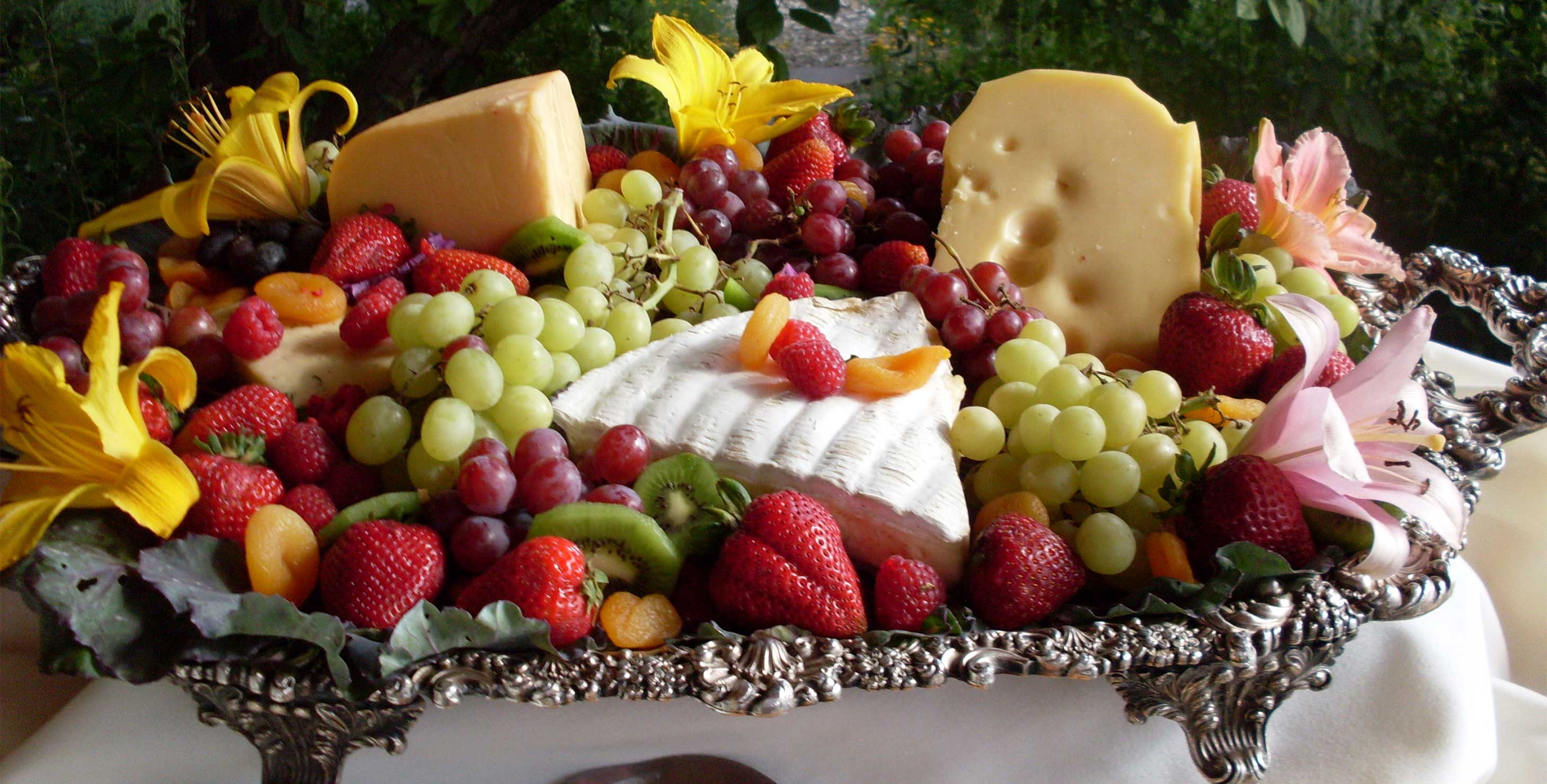A large tray of fruit and cheese
