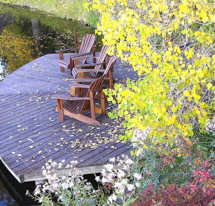 Adirondack chairs on the dock at Blue Lake Ranch with fall foliage.