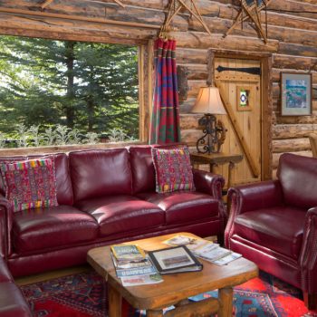 cozy cottage style colorado lodging with burgundy sofa