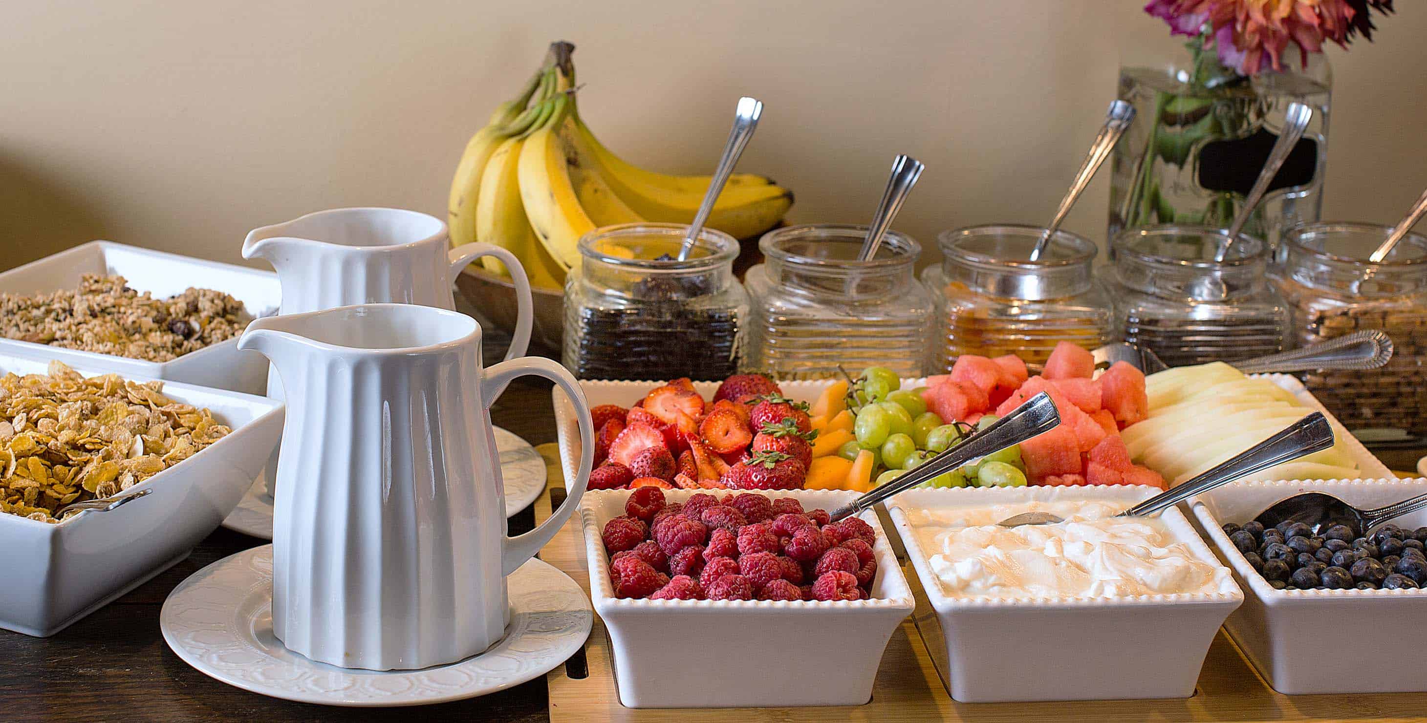 Breakfast buffet with a variety of fruit and cereals